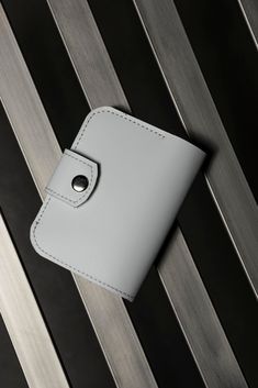 This wonderful white bifold wallet -- a perfect combination of elegance and practicality. Crafted from high-quality leather, it features a slim design and plenty of pockets for convenient storage of cash, credit cards, and coins. With customization options available, this wallet makes a unique gift, ideal for both yourself and your loved ones. It's more than just an accessory -- it's an expression of your style and individuality that will elevate your look in any situation. Material: genuine lea White Bifold Card Holder With Interior Slots, White Rectangular Card Holder With Card Slots, White Rectangular Card Holder With Slots, White Rfid Blocking Card Holder For Daily Use, White Rectangular Card Holder, Elegant White Rectangular Card Holder, Elegant White Wallet As A Gift, Elegant White Wallets For Gift, Elegant White Wallet As Gift