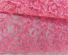 pink lace fabric with flowers and leaves on it