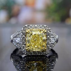 This stunning diamond ring creates a lasting impression through its colorful demeanor. The center stone is a luxurious 2.00 carat radiant cut, fancy yellow diamond. This impressive diamond glows with a beautiful color hue along side its fiery attributes for a glorious effect. Metal : 14k Gold, 18k Gold, or Platinum Setting Type : U-Pave, Bezel, Prong Total Carat Weight : 3.26 Carats Type : Natural Genuine Diamond Shape : Radiant Cut Carat Weight : 2.00 Ct.( GIA Certified) Cut : Excellent Color : Dazzling Square-cut Diamond Ring, Luxury Yellow Diamond Ring, Yellow Diamond Ring For Anniversary, Square Cut Diamond Rings With Diamond Cut, Yellow Diamond Ring With Emerald Cut, Elegant Yellow Diamond Ring With Brilliant Cut, Yellow Emerald-cut Diamond Ring, Fine Jewelry Diamond Ring Cubic Zirconia Radiant Cut, Dazzling Brilliant Cut Yellow Diamond Ring