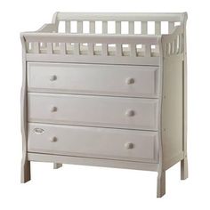 a white baby crib with three drawers