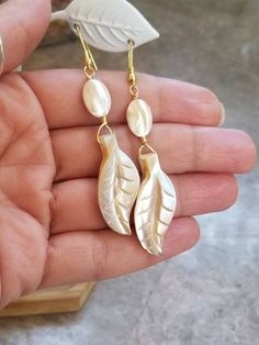 Mother of Pearl Earrings, Stainless Steel Earrings, MOP, Gold Earrings, Boho Earrings, Shell Earrings, Gemstone Earrings, Pearl Earrings, Plant, Leaf The earring hooks are stainless steel. These beauties are 3 inches long and have a beautiful sheen in the light. Mother of Pearl can be an part of anyone's path to releasing old emotions or deepening their spiritual connection. Wearing Mother of Pearl jewelry is said to attract prosperity, heighten intuition, and stimulate the imagination. Leaf-shaped Single Earring As A Gift, Mother Of Pearl Matching Drop Earrings Jewelry, Mother Of Pearl Single Earring For Gift, Mother Of Pearl Drop Earrings With Matching Earrings, Mother Of Pearl Drop Earrings With Matching Set, Mother Of Pearl Single Earring As A Gift, Single Mother Of Pearl Earring For Gift, Single Mother Of Pearl Earring As A Gift, Leaf-shaped Earrings For Gift