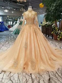 a ball gown with gold sequins is on display in a store window at night