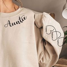 Give Mom, Aunt or Grandma a wardrobe refresh with our Personalized Sweatshirt! Personalize this sweatshirt with your choice of heart color, title and names that are printed on the sleeves of the sweatshirt. A heartwarming gift she'll always treasure and she'll love wearing!Our custom sweatshirt makes for great gifts on any occasion, such as birthday gifts, Christmas Eve, Thanksgiving gifts. Let’s make a one-of-a-kind gift for the important women in your life.PRODUCT DETAILS: 100% cotton (99% for Personalized Long Sleeve Hoodie For Gift, Personalized Long Sleeve Cotton Hoodie, Long Sleeve Relaxed Fit Hoodie As Gift, Relaxed Fit Long Sleeve Hoodie As Gift, Custom Text Long Sleeve Sweatshirt As A Gift, Customizable Crew Neck Sweater For Fall, Personalized Sweatshirt For Gift, Personalized Long Sleeve Sweatshirt Gift, Personalized Sweatshirt Gift