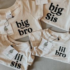 three t - shirts with the words big sis and lil sis on them are laid out next to each other