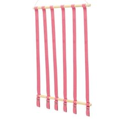 pink clothes pegs hanging from a wooden rack on a white background with clippings