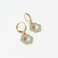 Classic, delicate earrings that lend a nostalgic yet whimsical vibe. Color: Teal, Orange, White, Gold Material: Alloy Dimensions: 1.25"L Overall, 0.5" Pendant Diameter Blue Vintage Hoop Earrings For Gifts, Blue Vintage Hoop Earrings As Gift, Blue Vintage Hoop Earrings For Gift, Vintage Blue Hoop Earrings For Gift, Retro Hypoallergenic Earrings For Gift, Retro Flower Earrings For Gift, Retro Enamel Earrings As Gift, Retro Flower Shaped Earrings For Gift, Retro Flower Shape Earrings For Gift