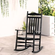 a black rocking chair sitting on top of a patio