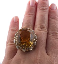 Buccellati cocktail ring in 18k gold, with center approx. 32ct citrine (stone measures 23.2 x 19.9 x 13.15mm) and approx. 2.10ctw Si/H diamonds. DESIGNER: Buccellati MATERIAL: 18k Gold GEMSTONES: Diamond, Citrine DIMENSIONS: Ring size 6, top is 30mm x 26mm. MARKED/TESTED: Buccellati, Italy, 18k. WEIGHT: 18 grams CONDITION: Excellent/Previously Owned Condition Formal Orange Topaz Ring With Diamond, Gold Cocktail Rings, Antique Jewelry Rings, Jewels Rings, Bold Jewelry, Gold Cocktail Ring, Gold Cocktail, Indian Wedding Jewelry, Citrine Stone