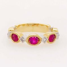 This "Ruby Romance" ring is gorgeous!! The rubies are round, faceted gemstones that are set in oval, milgrain bezels. The oval settings give the rubies an elongated look that's innovative and alluring! Set in between each ruby is a square-cut or princess cut, white diamond! The diamonds are natural diamonds that are bright white and very clean! The diamonds are set, on point, in white gold, square bezels with matching milgrain beading framing each stone. We currently have this ring with rose gol Classic Oval Lab-created Ruby Diamond Ring, Luxury Oval Three-stone Ruby Ring, Oval Diamond Ring With Lab-created Ruby Accents, Oval Ruby Ring With Three Diamonds, Oval Three Stone Ruby Ring With Diamonds, Oval Red Ruby Ring With Three Stones, Oval Lab-created Ruby Rings With Rose Cut Diamonds, Luxury Oval Rings With Rose Cut Diamonds And Ruby, Luxury Bezel Set Ruby Ring