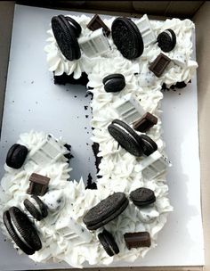 an oreo cookie and cream letter cake in a box