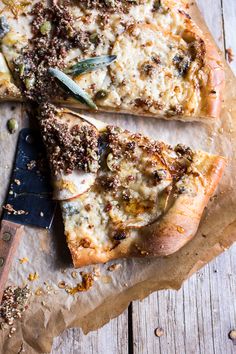 two slices of pizza sitting on top of a piece of paper next to a knife