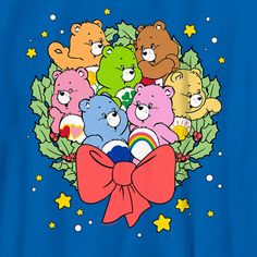 a group of teddy bears sitting on top of a christmas wreath