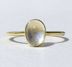 Iridescent, soothing and beautiful. This rainbow moonstone ring is made from 14k solid gold or 14k solid white gold material. Set with a natural rainbow moonstone. Whether you're buying this beautiful moonstone ring as a gift or for yourself, it will help with inter growth and strength and bring forth new beginnings and inspiration. Handmade in Los Angeles, CA! Each stone is unique and there may be slight color and height differences. We handpick the most beautiful stones! Fast Shipping: It will 14k Gold Oval Cabochon Moonstone Ring, White Moonstone Oval Cabochon Ring In 14k Gold, 14k Gold Oval Moonstone Ring, 14k Gold White Moonstone Oval Cabochon Ring, Oval Moonstone Ring In 14k Gold, White Oval Cabochon Moonstone Ring In 14k Gold, Oval Moonstone Halo Ring, Yellow Gold Moonstone Ring With Halo, Yellow Gold Oval Moonstone Promise Ring