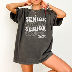 a woman posing with her hands on her head and wearing a shirt that says senior senior senior