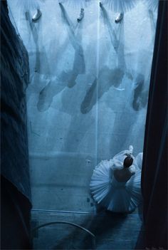 a woman in a white dress is standing next to a shower