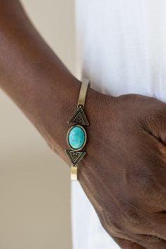 A smooth turquoise stone is pressed into the center of a dainty brass cuff. Stamped in geometric patterns, a pair of brass triangular frames flank the stone centerpiece for a tribal inspired finish. Sold as one individual bracelet. P9SE-BRBL-046XX Paparazzi Accessories Jewelry, Brass Cuff Bracelet, Brass Cuff, Turquoise Bracelet Cuff, Brass Bracelet, Turquoise Cuff, Paparazzi Accessories, Faux Stone, Blue Jewelry