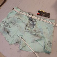 Light Pale Turquoise & Grey Camo Pattern Summer Sports Bottoms In Turquoise, Light Blue Moisture-wicking Bottoms For Summer, Blue Under Armour Summer Shorts, Blue Summer Activewear With Drawstring, Summer Blue Activewear With Drawstring, Under Armour Blue Shorts For Summer, Under Armour Summer Shorts With Pockets, Under Armour Summer Athleisure Shorts, Summer Gym Shorts By Under Armour