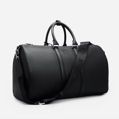 Explore elegance and utility in our Saffiano Leather Duffle Bag. Featuring intricate silver detailing and the GC logo, it makes a statement of sophistication. With two inside pockets and a removable shoulder strap, it's designed for versatility and functionality. Elevate your journey with this exquisite duffle bag. SIZE W 50 x H 29 x D 24 cm Luxury Duffel Bag, Black Leather Duffle Bag, High-end Epsom Leather Bag For Everyday Luxury, Luxury Large Capacity Shoulder Bag, Elegant Epsom Leather Shoulder Bag For Everyday Luxury, High-end Epsom Leather Shoulder Bag For Everyday Luxury, Everyday Luxury Epsom Leather Shoulder Bag With Detachable Strap, Luxury Saffiano Leather Shoulder Bag With Detachable Strap, Elegant Epsom Leather Bag For Everyday Luxury