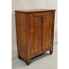 an old wooden cabinet with two doors on one side and a drawer on the other