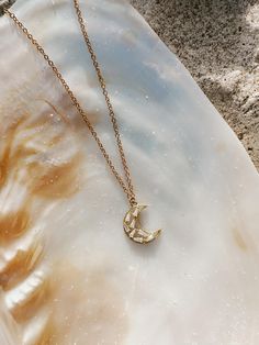 A petite crescent moon adorned with cubic zirconia gemstones is hung on a simple gold plated chain. Moon measures a little over 0.5" long. Chain is 17". Length of chain can be adjusted upon request. Gold Necklace With Moon Charm And Cubic Zirconia, Gold Necklace With Moon Charm In Cubic Zirconia, Dainty 14k Gold Filled Crescent Necklaces, Mosaic Moon, Gold Crescent Moon Necklace, Crescent Moon Necklace Gold, Gold Crescent Moon, Crescent Moon Necklace, Moon Necklace