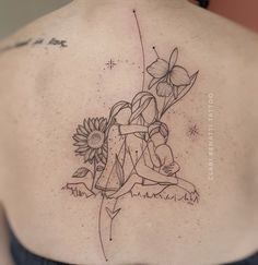 the back of a woman's shoulder with flowers on it