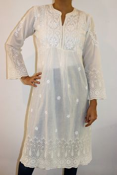 Discover timeless elegance with our Cotton Cutwork Dress in natural cream, adorned with exquisite chikankari hand embroidery. This stunning dress features a refined split neckline with a yoke, complemented by full sleeves and intricate cutwork embroidery on the hem and sleeve hem. Measuring 47/48 inches in length, this dress effortlessly combines traditional craftsmanship with modern sophistication, making it a must-have addition to your wardrobe. Embrace the beauty of artisanal detail and superior comfort with this captivating piece. The dress comes with a matching liner. Sizes -  S - fits bust 34 M - fits bust 36 L - fits bust 38 XL - fits bust 40 0X - fits bust 42 1X - fits bust 44 Prewashed. Preshrunk. Cutwork Dress, Cutwork Embroidery, Natural Cream, Full Sleeves, Cut Work, Stunning Dresses, Dress Clothes For Women, Full Sleeve, Hand Embroidery