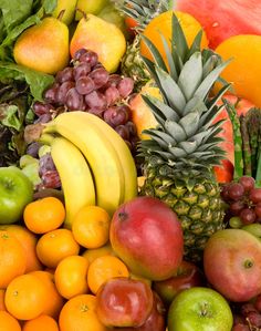 an assortment of fresh fruits including bananas, apples, oranges and watermelon