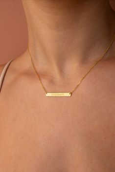 Elegant 14k solid gold bar necklace, handcrafted and personalized with a beautiful script name, epitomizing luxury, identity, and unparalleled craftsmanship. Gold Rectangular Minimalist Name Necklace, Personalized Nameplate Necklace For Everyday, Minimalist Name Necklace For Birthday Gift, Gold Nameplate Necklace For Everyday, Minimalist Gold Engraved Bar Necklace, Gold Rectangular Pendant Name Necklace For Everyday, Minimalist Engraved Gold Bar Necklace, Mother's Day Everyday Nameplate Necklace, Minimalist Bar Necklace For Mother's Day Personalized Gift