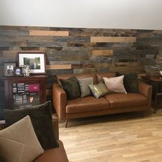 a living room filled with furniture and wooden walls