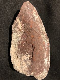 a large rock sitting on top of a black surface