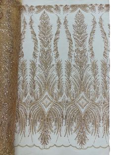 an embroidered gold and white fabric with sequins