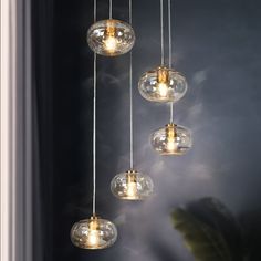 five clear glass balls hanging from a ceiling