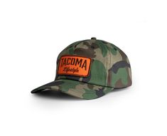 Designed with the rugged spirit of exploration in mind, this hat combines style, functionality, and durability to keep you comfortable on your overland journeys. Camo with an embroidered hunter orange patch logo with a snapback enclosure. All-Day Comfort Protection Against the Elements One Size Fits All Outdoor Trucker Baseball Cap With Letter Patch, Trucker Baseball Cap With Letter Patch For Outdoor, Outdoor Brown Baseball Cap With Letter Patch, Outdoor Trucker Hat With Letter Patch And Curved Brim, Brown Trucker Hat With Letter Patch For Outdoor, Outdoor Flat Brim Hat With Logo Patch, Brown Snapback Hat With Letter Patch For Outdoor, Outdoor Cap With Letter Patch, Outdoor Hats With Letter Patch And Curved Brim