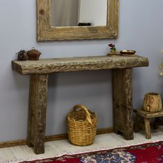 a wooden bench sitting under a mirror next to a basket