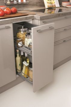 an open cabinet in the middle of a kitchen