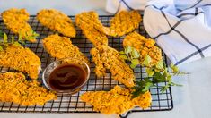 fried chicken sticks with ketchup on a cooling rack