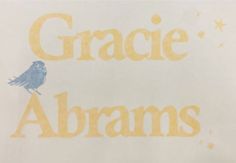 the words grace and abrams written in yellow on a white background with a blue bird