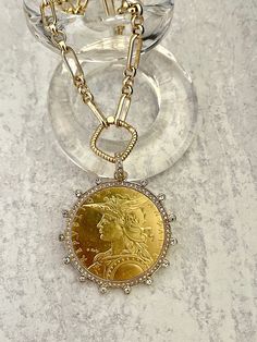 Beautiful reproduction vintage coin pendant, French Madagascar coin in a bezel with cubic zirconia stones. The bale attached to the coin is also encrusted with CZ stones. The coin is 22k gold plated and elegantly hangs from a multi link gold plated brass chain and a rope design spring lock clasp. The spring lock closure not only makes it easy to open and close the necklace for those with difficulty but adds to the creativity of the jewelry piece. Please see photograph of how to open the clasp. W Gold Coin Necklace, Rope Design, Gold Coin, Coin Necklace, Gold Chain Necklace, Coin Pendant, Keep Jewelry, Gold Coins, Brass Chain