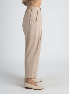 KAAREM - Seed Pleated Tapered Pant w/ Elastic (Unisex) - Dark Cream Cream High-waisted Linen Pants, High-waisted Tapered Linen Pants, High-waisted Cream Linen Pants, Tapered High-waisted Linen Pants, Neutral Linen Bottoms For Business Casual, Business Casual Neutral Linen Bottoms, Cream Linen Workwear Pants, Cream Linen Pants For Work, Neutral Linen High-waisted Pants