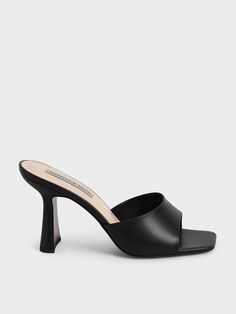 Sleek Black Slip-on Mules, Modern Black Mules With Padded Heel, Sleek Black Square Toe Mules, Black Sandals With Deep Heel Cup And Square Toe, Sleek Mules With Padded Heel For Work, Sleek Open Heel Mules For Office, Modern Fitted Mules For Workwear, Classic Black Mules, Black Square Toe Mules With Sculpted Heel