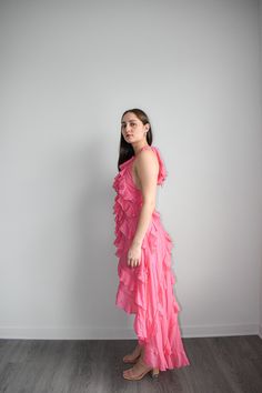 Elevate your style with our Pink Asymmetrical Maxi Dress. This stunning dress features a solid halter neckline and asymmetrical ruffle detail, adding a touch of elegance and uniqueness to your look. Crafted from a blend of 75% Rayon and 25% Polyester, with a 100% Rayon lining, it provides maximum comfort and breathability. Perfect for any occasion, this beautiful pink dress is designed to make you stand out in any crowd. Whether you're attending a special event or a casual gathering, this Pink A Feminine One Shoulder Ruffle Dress For Spring, Feminine Spring One Shoulder Dress With Ruffles, Feminine One-shoulder Ruffled Dress For Spring, Feminine Spring One-shoulder Dress With Ruffles, Feminine One-shoulder Spring Dress With Ruffles, Spring Dress With Asymmetrical Neckline And Ruffles, Spring Dress With Ruffles And Asymmetrical Neckline, Spring Pink One Shoulder Dress With Ruffles, Pink One Shoulder Dress With Ruffles For Spring