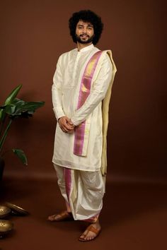 Off-white pattu kurta featuring floral embroidery on the neckline and sleeve hem. Paired with a contrast pink hem dhoti pant and a kanduva. - Aza Fashions Simple Stage Decorations, Kurta For Men, Kurta Set For Men, Wedding Outfit Men, Dhoti Pants, Beaded Neckline, Embroidery Floral, Stage Decorations, Fashion App