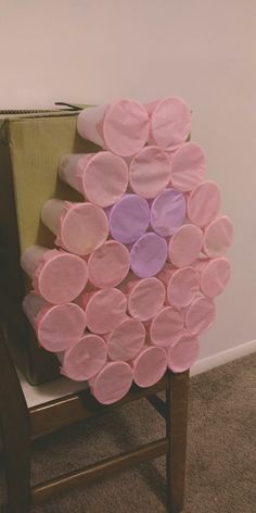 a chair made out of pink and purple circles on top of a carpeted floor