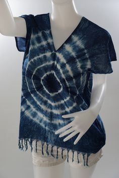 a mannequin wearing a blue and white tie - dyed shirt with fringes