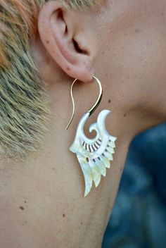 Handcrafted with love and intention, our exquisite Brass Feather Earrings are a testament to the beauty of nature and artistic craftsmanship. Each pair is meticulously created using ethically sourced Abalone shell and high-grade nickel-free brass. Inspired by the gentle curves and flowing forms found in nature, these stunning designs capture the essence of elegance and grace. The lightweight construction ensures a comfortable wear, allowing you to effortlessly elevate any outfit with a touch of unique sophistication. Whether you are embarking on a tranquil nature walk or dancing joyfully at a festival with friends, these beautiful earrings will be your statement piece, inspiring you to embrace your inner boldness. They are a reminder to celebrate your individuality and embrace the freedom Handmade Natural Shell Jewelry, Handmade Shell Jewelry In Natural Color, Handmade Natural Shell-shaped Jewelry, Bohemian White Mother Of Pearl Earrings, Natural Shell Jewelry For Festivals, Natural Jewelry For Pierced Ears As A Gift, Natural Color Jewelry For Pierced Ears As A Gift, Natural Color Jewelry For Gifts With Pierced Ears, Bohemian Mother Of Pearl Drop Earrings