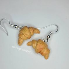 Croissant Earrings Croissants measure approximately between 1.5cm to 2.25cm Materials: ▫ Polymer Clay ▫ Hypoallergenic Hanging Earring Hook Each Croissant is handmade by me, so you may receive a pair of earrings that are slightly different from the ones pictured in the listing. As they are all made by hand all are similar but no two pairs will ever be the same! I can also do custom orders. Please feel free to send me a message with any questions or ideas! Thanks for checking out my shop! Handmade Adjustable Cartilage Earrings For Everyday, Adjustable Drop Cartilage Earrings As Gift, Handmade Drop Cartilage Earrings As Gift, Handmade Dangle Cartilage Earrings As Gift, Handmade Dangle Cartilage Earrings For Gift, Adjustable Clip-on Earrings With Ear Wire As Gift, Hypoallergenic Adjustable Wrap Earrings For Gift, Adjustable Nickel-free Polymer Clay Earrings, Hypoallergenic Resin Jewelry For Everyday