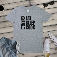 "For the Cook or Chef in your life  Please note we only use Gildan branded \"Softstyle\" T-shirts, not cheaper unbranded t-shirts. These are 100% preshrunk super soft cotton They will last for many years along with the print itself Size Guide (inches)  SMALL 36\" chest and 28\" collar to hem MEDMIUM 40\" and 29\" collar to hem LARGE 44\" chest and 30\" collar to hem X LARGE 48\" chest and 31\" collar to hem 2X LARGE  52\" chest and 32\" collar to hem 3X LARGE 56\" chest and 33\" collar to hem actual measurements can vary slightly due to the manufacturing process We are a family owned UK based t-shirt design and printing business that has operated for over 10 years. We feel our longevity is down to using superior quality materials such as Gildan t-shirts and industry quality ultra thin and Basic Comfortable Fit T-shirt With Letter Print, Graphic Tee Tri-blend Pre-shrunk T-shirt, Tri-blend Crew Neck T-shirt With Band Merch, Graphic Tee T-shirt In Pre-shrunk Ring-spun Cotton, Tri-blend Cotton Graphic Tee, Gray Band Merch Crew Neck T-shirt, Gray Band Merch T-shirt With Crew Neck, Gray Crew Neck Band Merch T-shirt, Gray Band Merch T-shirt With Screen Print