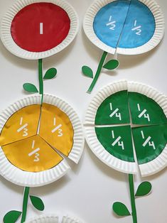 three paper plates with different numbers on them and one has a flower in the middle