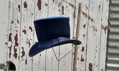 "Our brand-new series of classic, historical Top Hats is based on the \"Bridgerton\" period drama: this hat - a blue Top Hat - is inspired by one of the male characters - the Prussian Prince Friedrich.  This hat is made of high-quality leather and blue velvet and it features a classy blue leather hat band with an elegant bow and black trim. A sturdy, firm wire makes sure the hat keeps its characteristic shape. It will last for many years, even with lots of handling and wear. Please contact us re Blue Top Hat, Hat Aesthetic, Netflix Dramas, Leather Hat, Male Characters, Top Hats, Leather Hats, Hat Band, Blue Top