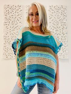 Welcome to LM Handmade Boutique! Perfect for layering in any season, more than just fashion--wearable art. Whether you're heading out for a casual day or dressing up for an evening event, this poncho adds a statement piece to your wardrobe. Limited Edition** Once it's gone, it's gone.   Get your one-of-a-kind poncho today and embrace your individuality with every wear! Step into a world where fashion meets craftsmanship. Each piece is lovingly handmade to create a truly one-of-a-kind piece.  No Bohemian Blue Top With Tassels, Beach Hippie Poncho With Tassels, Bohemian Poncho With Tassels For The Beach, Bohemian Poncho With Tassels For Vacation, Bohemian Beach Poncho With Tassels, Handmade Bohemian Poncho For Festival, Bohemian Multicolor Tops With Tassels, Handmade Bohemian Blue Tops, Multicolor Bohemian Top With Tassels